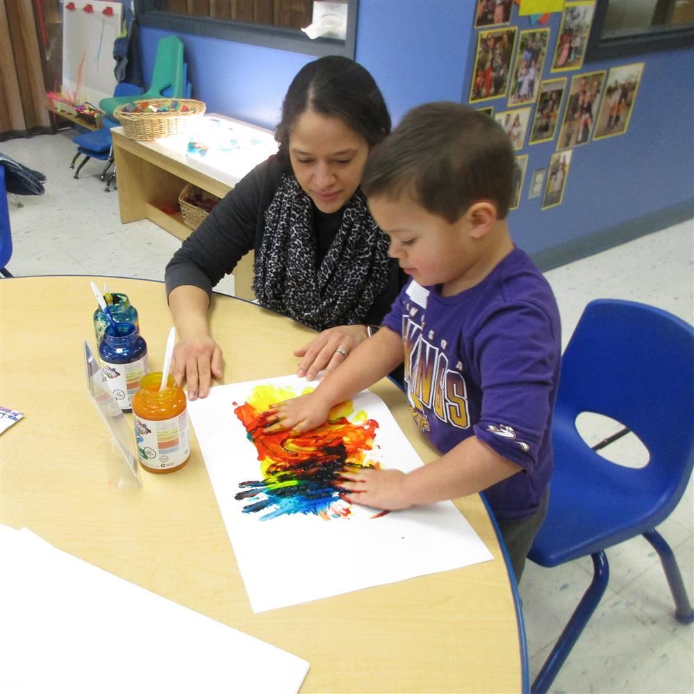  Adult and child working at table